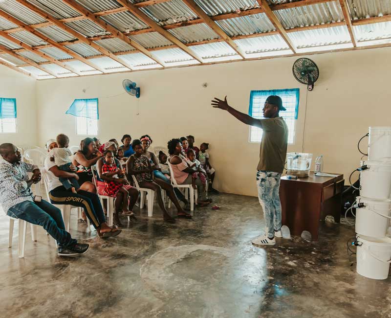 GBL team member teaching a community about clean water filtration